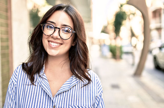 Female wearing glasses standing on the street