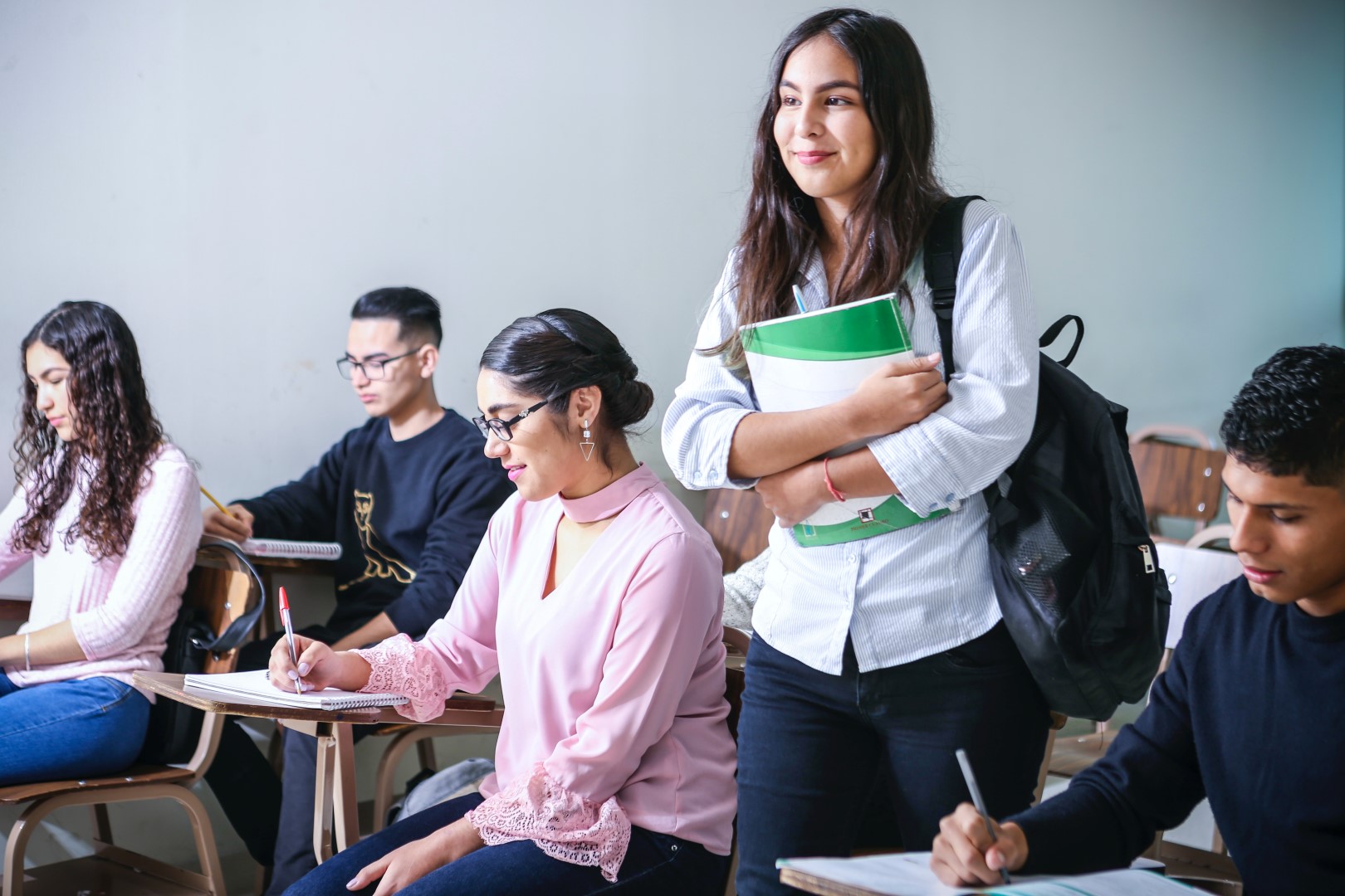 Girl standing up in class, still under her family GMHBA policy