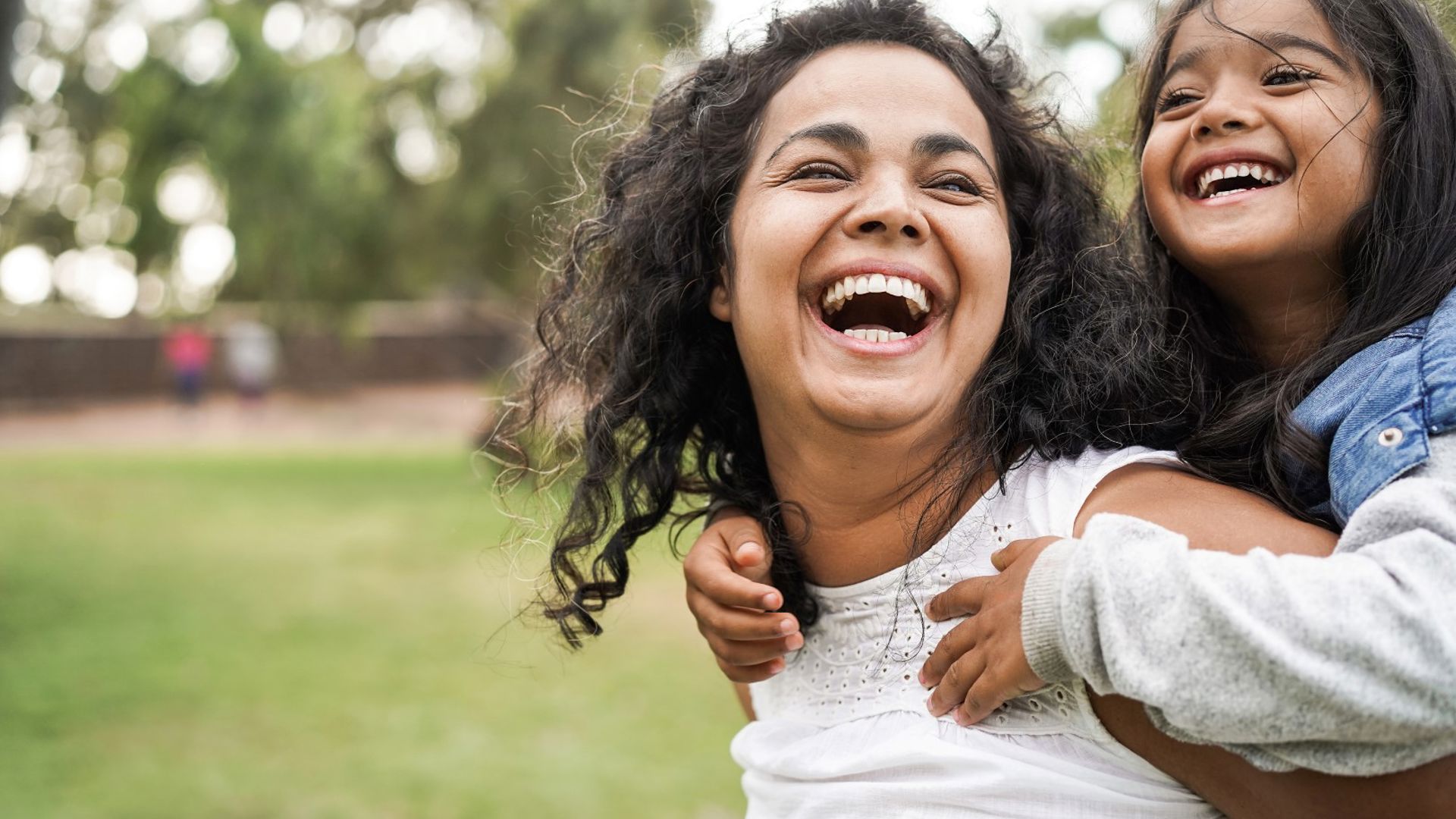 Daughter and mother spending time together in the park after joining GMHBA to avoid MLS at tax time