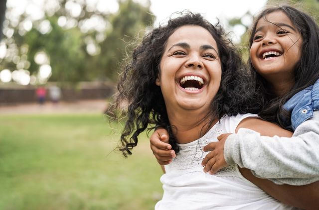 Daughter and mother spending time together in the park after joining GMHBA to avoid MLS at tax time