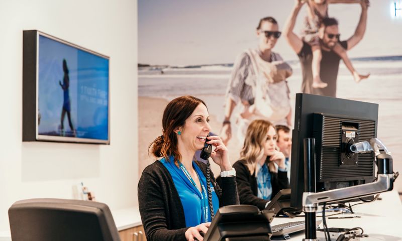 GMHBA employee laughing whilst at work