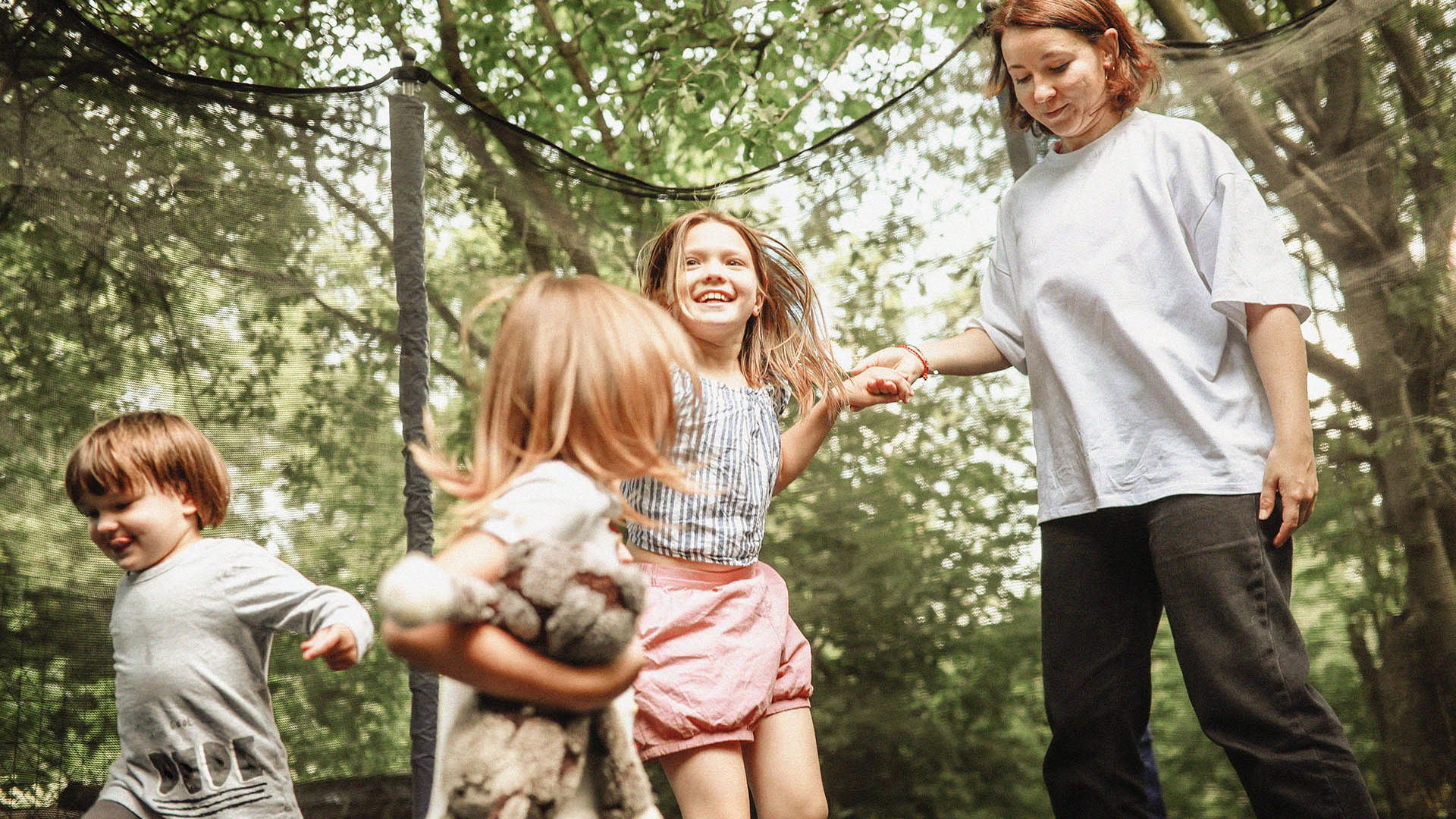 Kids playing safely and laughing with GMHBA Family cover health insurance.