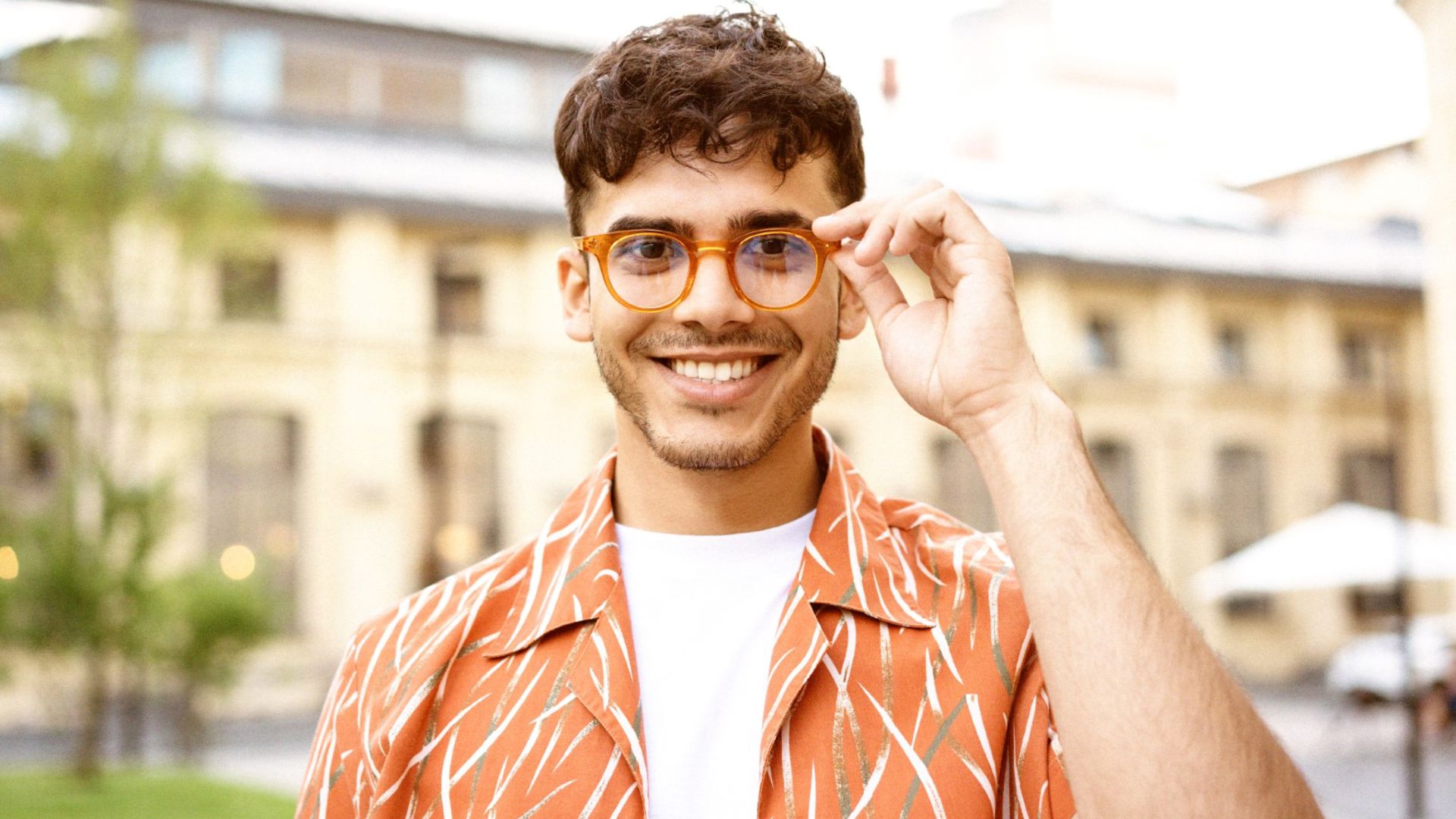 Young Man with glasses happy because he has optical extras and gets great Eye Care Benfits with GMHBA