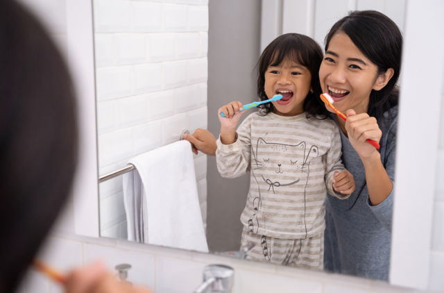 Mother and daughter brushing teeth.jpg