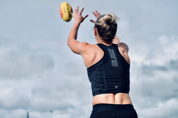 Woman playing football wearing Zena Sport