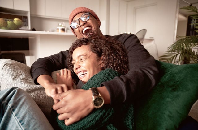 Couple cuddling on the couch talking about their health journeys