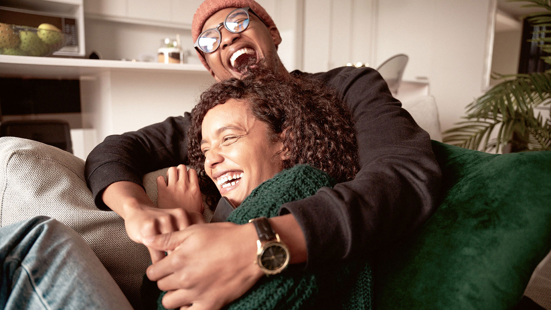 Couple cuddling on the couch talking about their health journeys