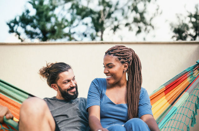 Young GMHBA couple relaxing in a hammock