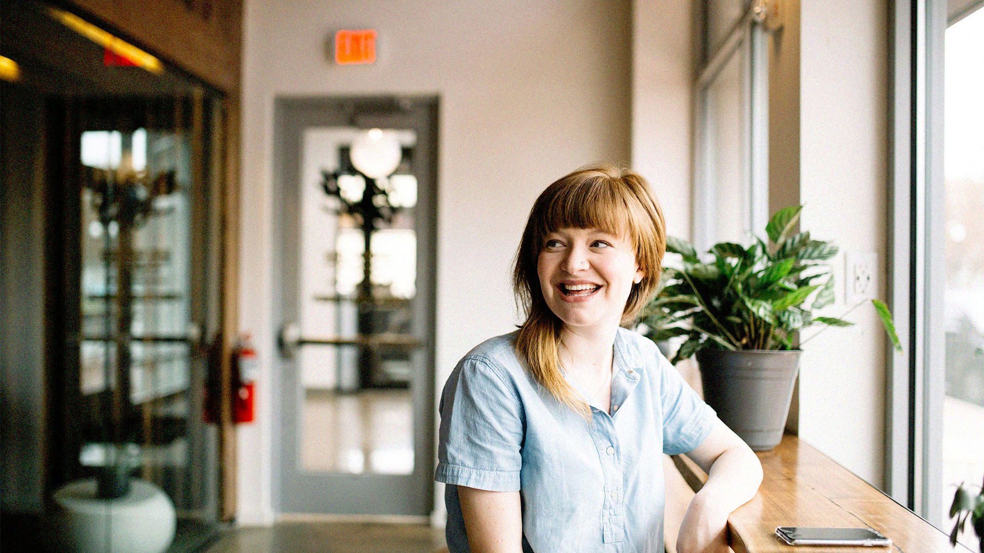 All Abilities woman sitting in cafe looking out the window