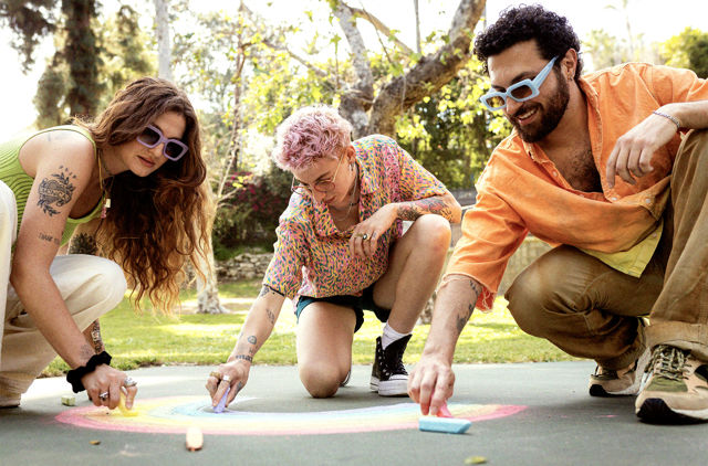 LGBTQIA plus group drawing on the ground in a park
